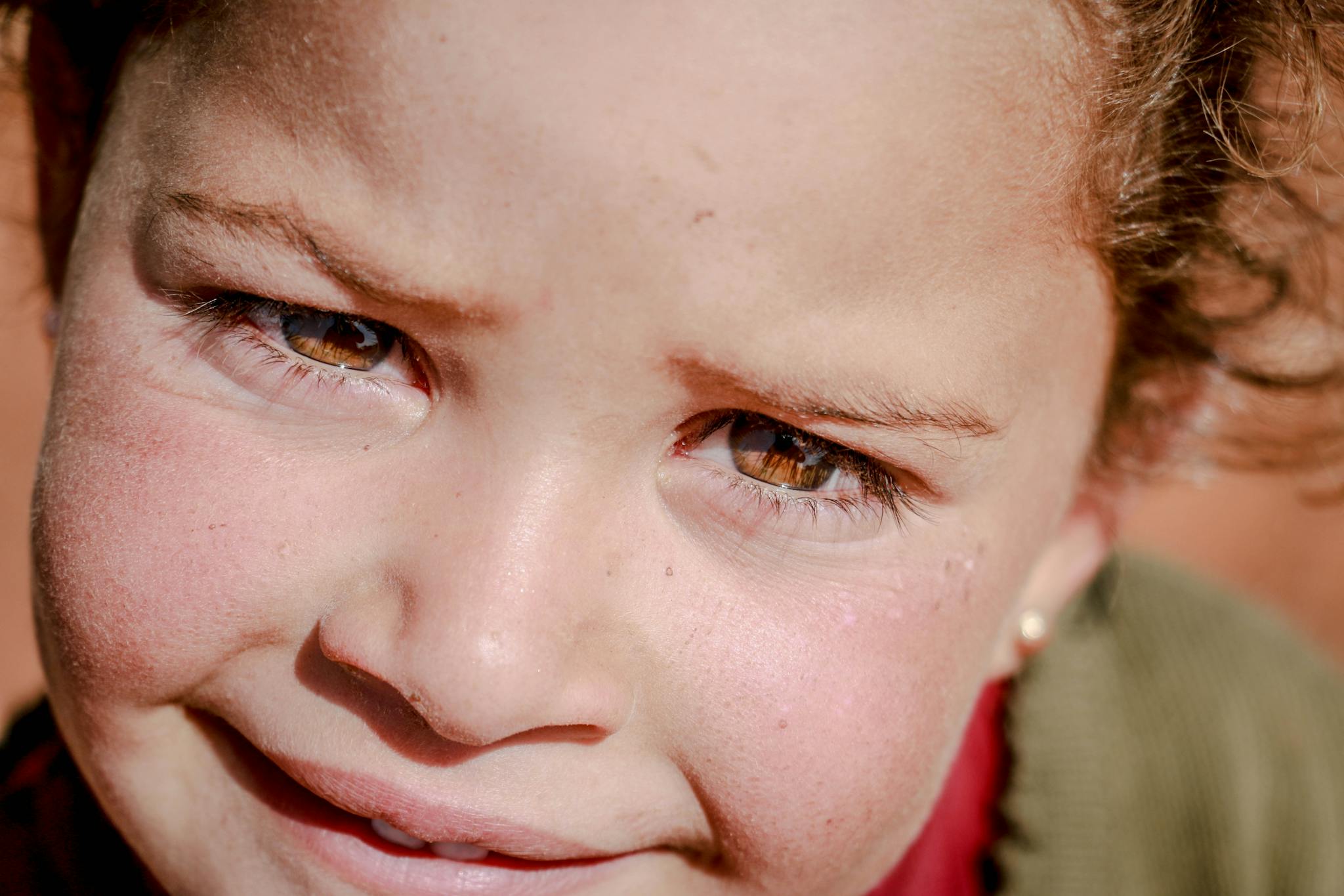 Extreme close-up of a child's face with a warm, natural expression in Idlib, Syria.